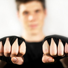 Burke wearing weight-lifting gloves with fists raised to camera