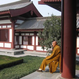 Image of a monk in a courtyard