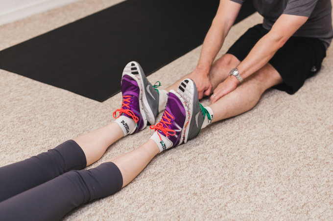 Scott and Jen share a stretch together at the end of the work out.